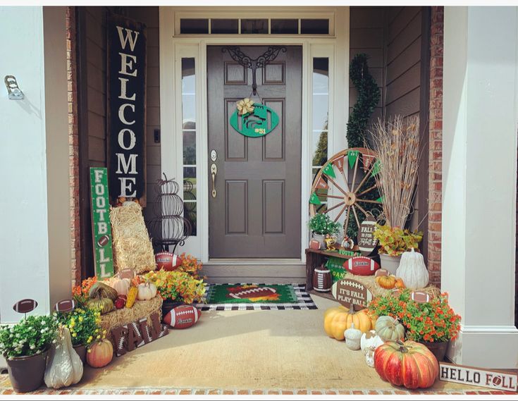 a front porch decorated for fall with pumpkins, gourds and other decorations