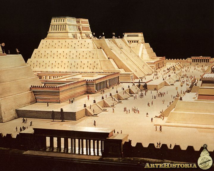 an aerial view of the pyramids and other structures at night, with people walking around