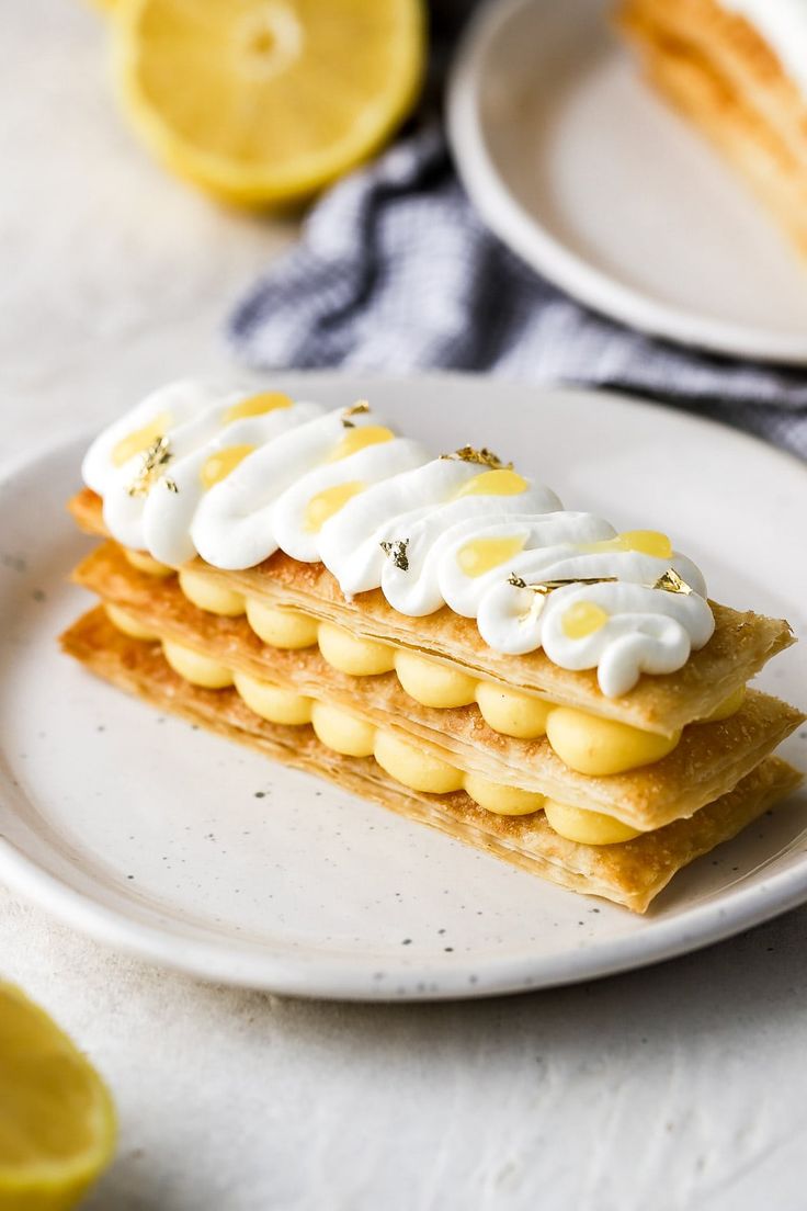 a piece of cake on a plate with lemon slices