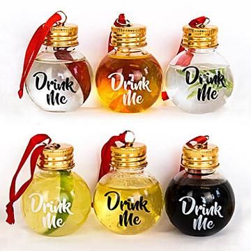 four different colored bottles with drink me written on them