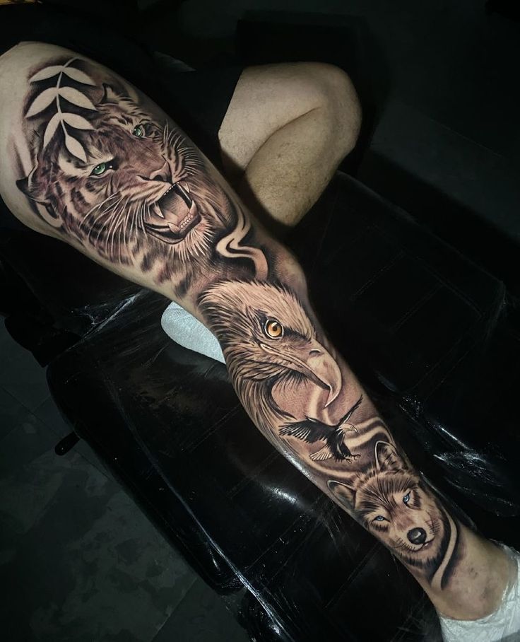 a man with a tattoo on his leg that has two lions and a lion head