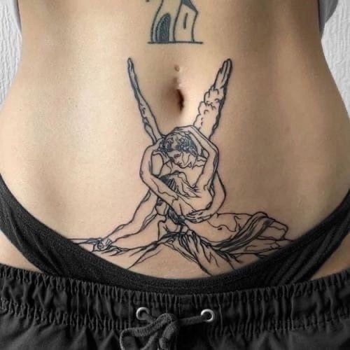 a woman with a tattoo on her stomach