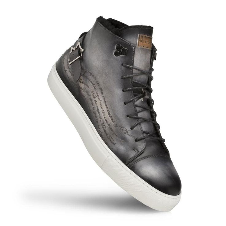 Style: Etched High Top Sneaker Grey Unique Patina High Top Sneaker from the Mezlan collection features one of a kind Engraving on Hand-Burnished Patina Calfskin, Faux Fur Lining, Monkstrap Detailing on the Heel, their injected memory foam cushioned insole and a full Rubber Cup Sole! Handmade in Spain. Styling High Top Sneakers, Cordovan Shoes, Hi Fashion, High Top Sneaker, Shoe Tree, Sneakers Grey, Monk Strap, Handmade Shoes, Wedge Sneaker