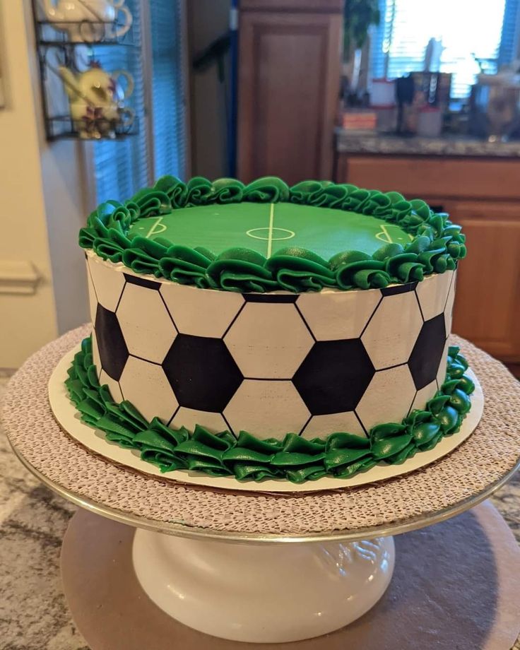 a soccer themed cake with green icing