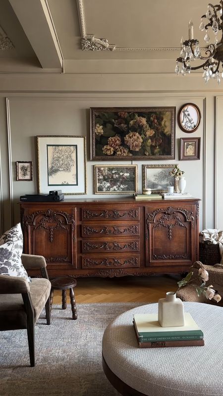 a living room filled with furniture and pictures on the wall