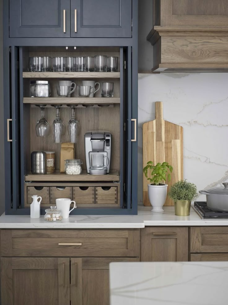 an open cabinet in the middle of a kitchen