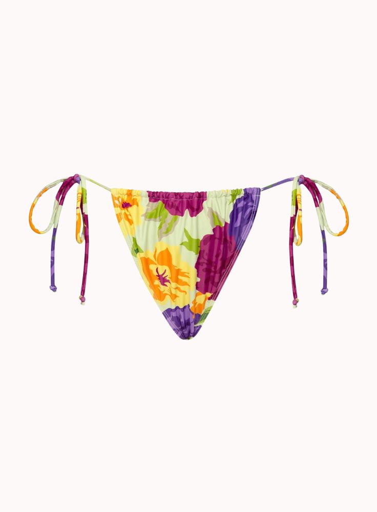 Leyna Bikini Bottom In Tropicana Brights features a low rise bikini bottom with oversized floral prints throughout. Co-cord with the Goby Skirt in Tropicana Brights. DETAILS Low rise bikini bottoms with adjustable ties at each side Ruching on the front and back for adjustable coverage Ivory base and bright pink, yellow and orange floral prints Shell: 80% polyester 20% elastane lining: 100% polyester Top Sold Separately Motel is a trendy and fashion-forward women's contemporary clothing brand tha String Swimwear With Drawstring For Vacation, Vacation String Swimwear With Drawstring, Vacation Beachwear With Tie-side Bottom, Multicolor Floral Print Bottoms For Sunbathing, Multicolor String Swimwear For Beach, Summer String Bottoms For Swimming, Multicolor String Swimwear For Poolside, String Bottoms For Beach Season, Multicolor Beachy Bottoms For Festival