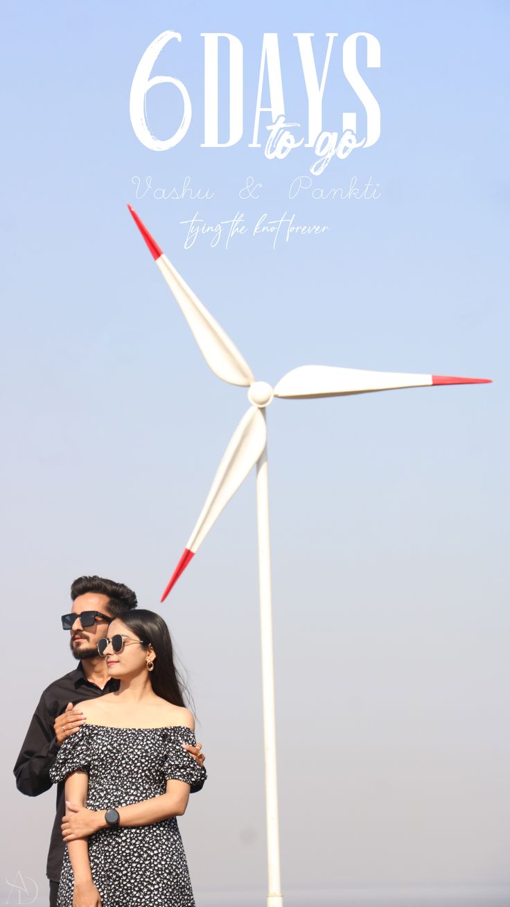 a man and woman standing in front of a wind turbine with the words 6 days written on it