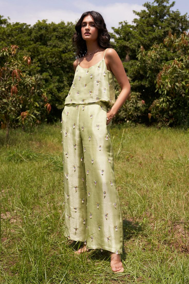 Lime sleeveless top with hand embroidered sequin work. Paired with a pant.
Components: 2
Pattern: Hand Embroidery
Type Of Work: Sequin
Neckline: Scoop Neck
Sleeve Type: Sleeveless
Fabric: Top and Pant: Viscose Tissue, Lining: Santoon
Color: Green
Other Details: 
Side pockets
Hand embroidered pant
Occasion: Resort - Aza Fashions Elegant Embellished Summer Pants, Chic Embellished Pants For Summer, Sleeveless Embroidered Summer Sets, Embroidered Sleeveless Summer Sets, Summer Embroidered Sleeveless Sets, Spring Sleeveless Sequin Sets, Spring Sequined Sleeveless Sets, Elegant Embellished Summer Pant Set, Sleeveless Sequin Sets For Spring