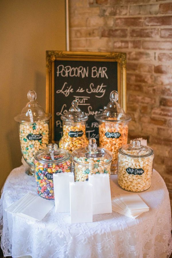 a table topped with lots of candy and candies next to a chalkboard sign