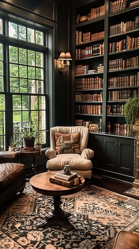 a living room filled with lots of furniture and bookshelves next to a window