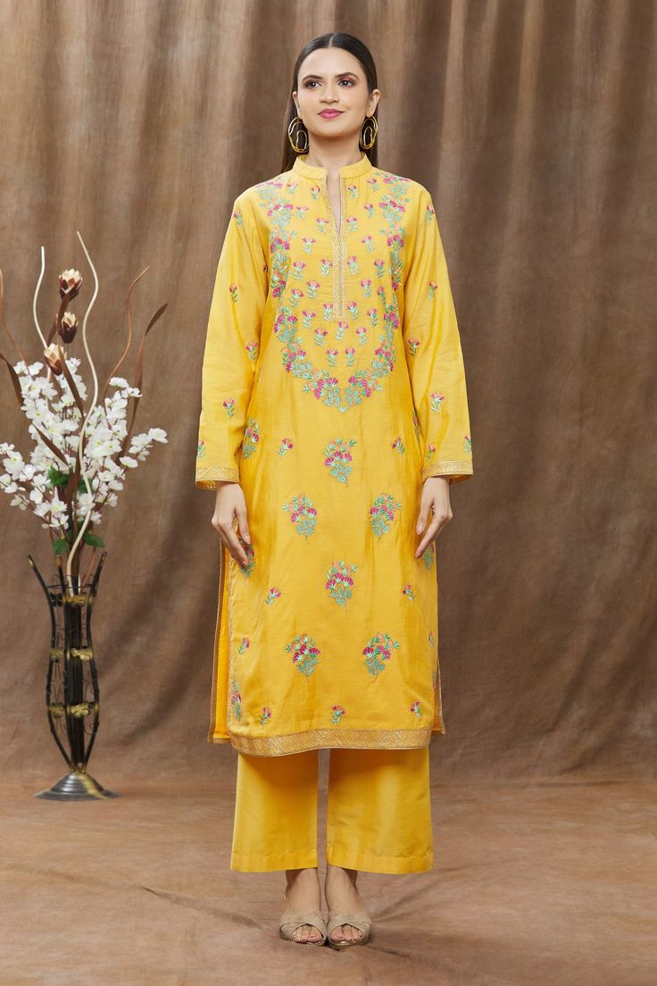 Mustard chanderi kurta with multicolor floral embroidery and chevron pattern on the hems. Comes with straight pants and woven dupatta.
Component: 3
Pattern: Embroidery
Type Of Work: Thread
Neckline: Band
Sleeve Type: Full
Fabric: Chanderi
Color: Yellow
Other Details: 
Dupatta with woven motifs
Side slits
Pant with pleats
Occasion: Puja - Aza Fashions Kurta Pant Set, Pattern Embroidery, Kurta With Pants, Fashion App, Chevron Pattern, Pant Set, Straight Pants, Set For Women, Embroidery Thread