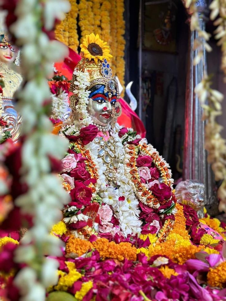 an idol is surrounded by flowers and garlands