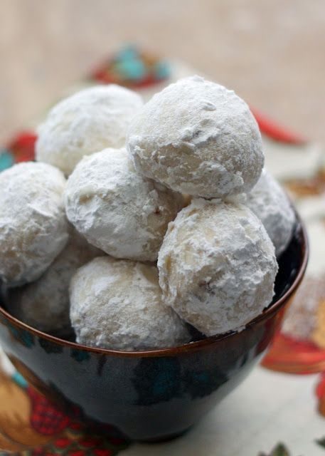 a bowl filled with powdered donuts on top of a table