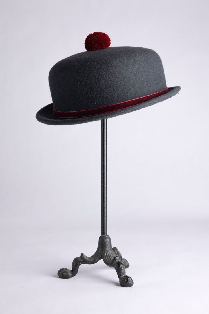 "A vintage inspired hat, this cute short-brimmed piece comes decorated with a velvet ribbon to match a cotton pompom sitting on top. Made out of wool felt, this hat has been stiffened enough so it can never be crushed! Choose between our two neutral options: a dark grey hat with burgundy velvet and pompom, or a dark brown piece with caramel ribbon and pompom. Brim size is 1\". Crown is 2\"1/2 high.  Can be adjusted to your head size (up to 23\" 1/2)" Winter Mini Hats With Short Brim In Felt, Curved Brim Felt Hat For Derby And Winter, Winter Derby Fedora Hat, Winter Derby Felt Hat With Flat Brim, Adjustable Felt Fedora Mini Hat, Winter Mini Hats With Short Brim, Winter Mini Felt Hats With Short Brim, Winter Derby Felt Hat With Curved Brim, Fur Felt Boater Hat For Kentucky Derby