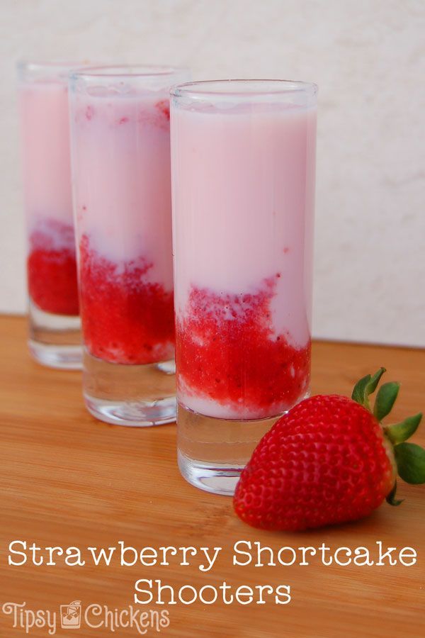 strawberry shortcake shots in glasses with strawberries on the side and text overlay that reads strawberry shortcake shots