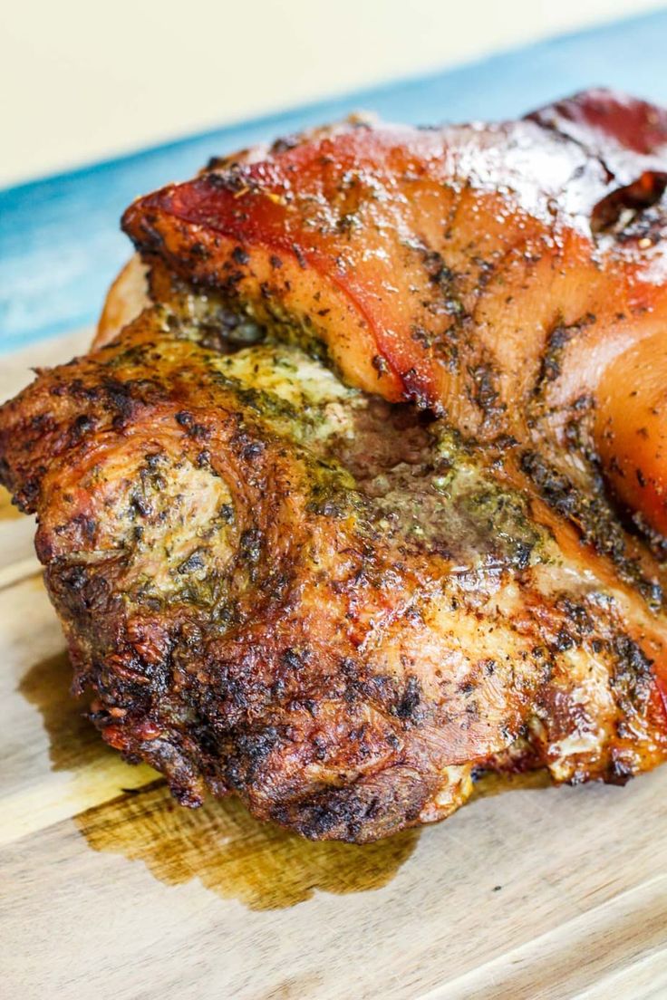 two pieces of meat sitting on top of a cutting board