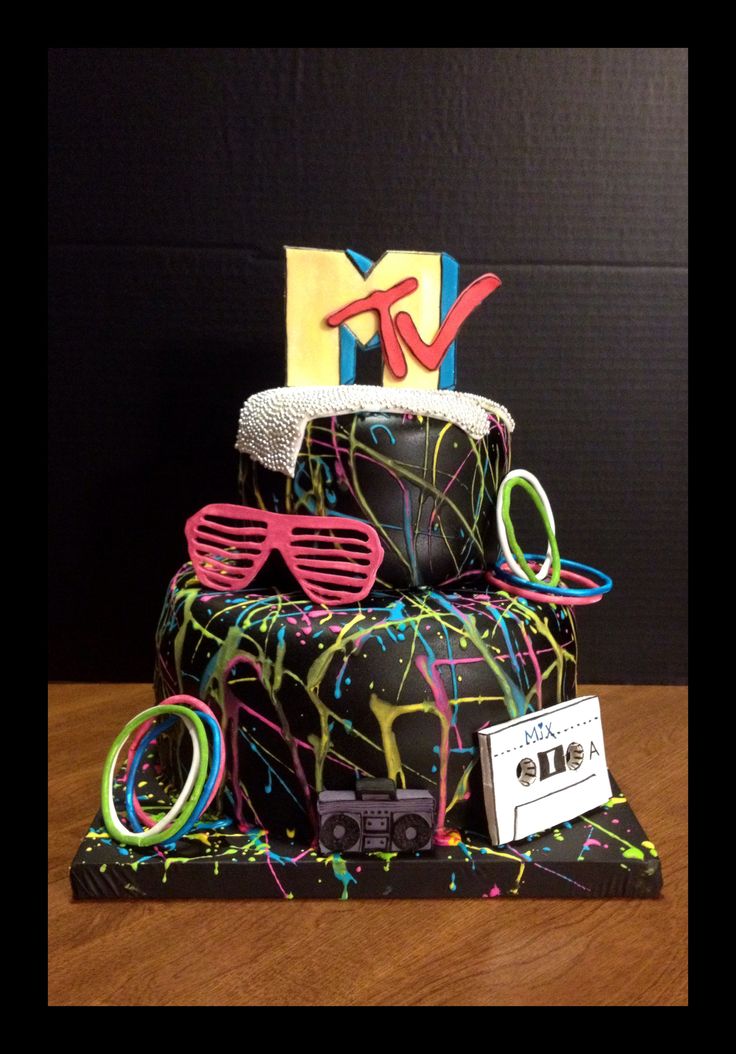 a birthday cake with glasses and a hat on it's top tier is decorated in neon colors