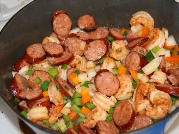 sausage and shrimp stir fry in a pan on the stove