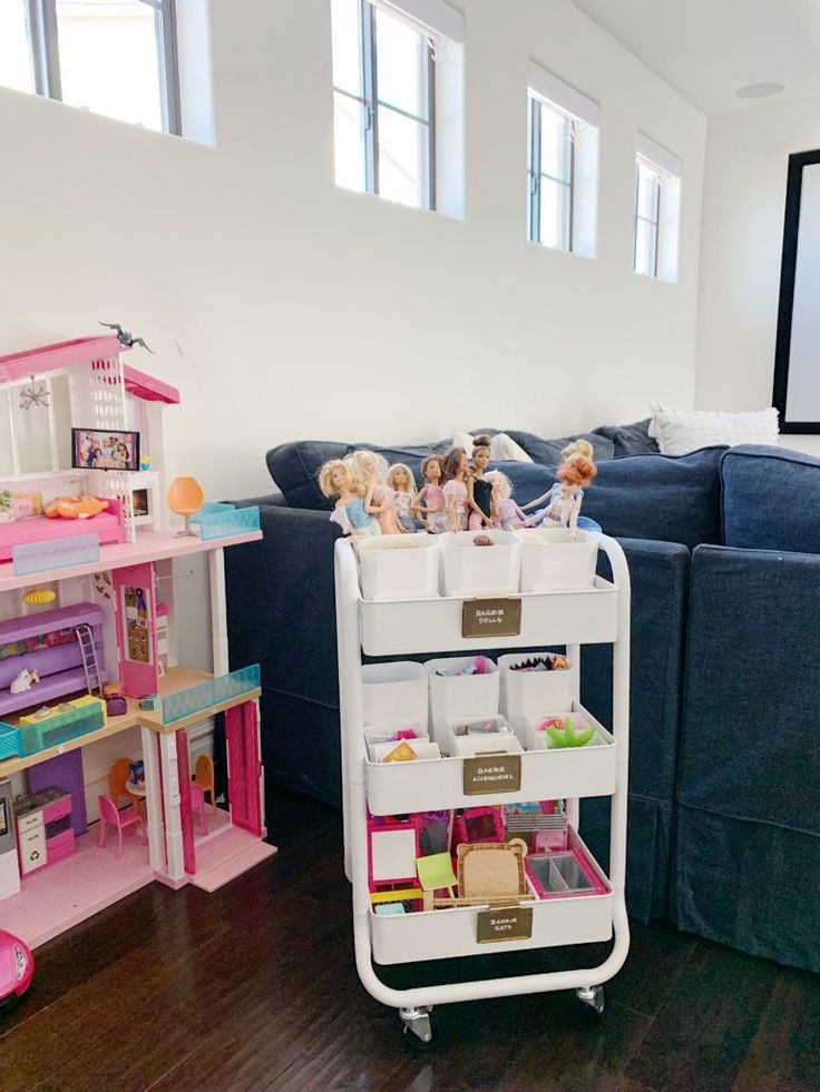 a living room filled with furniture and lots of doll accessories on top of a cart