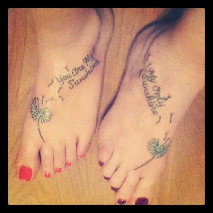 two people with tattoos on their feet and one has the words, you are my sunshine