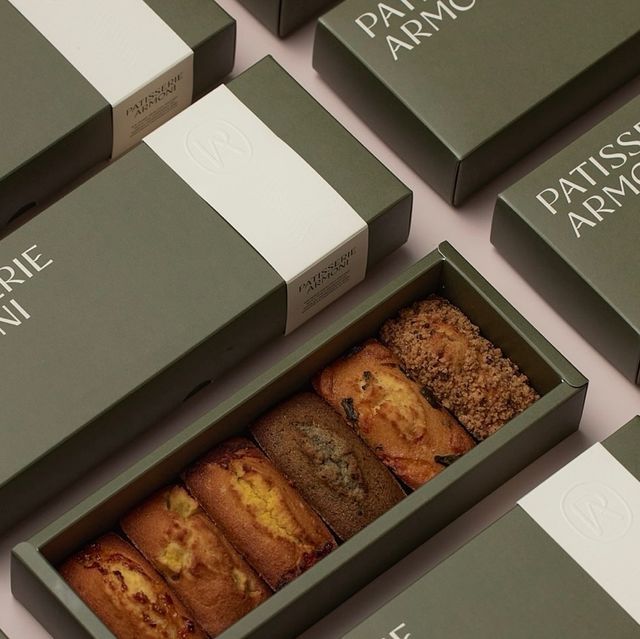 several boxes with different types of pastries in them