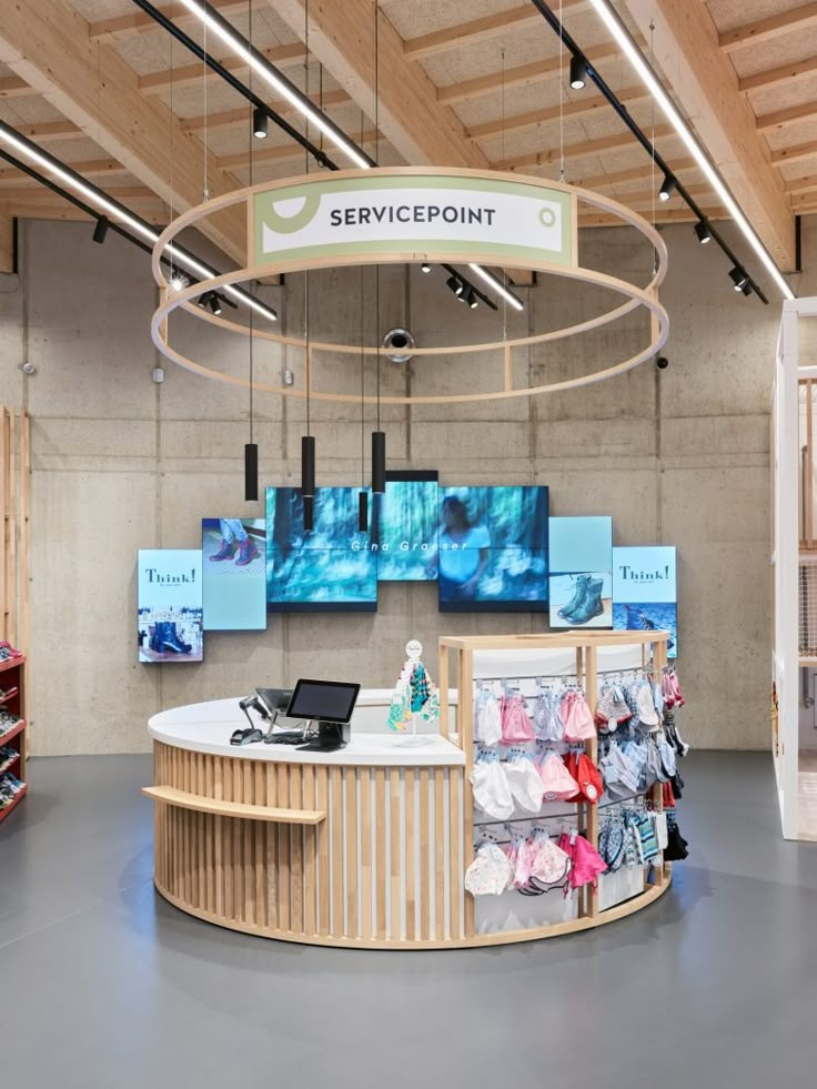 the service point is located in an open area with multiple displays on the wall and ceiling