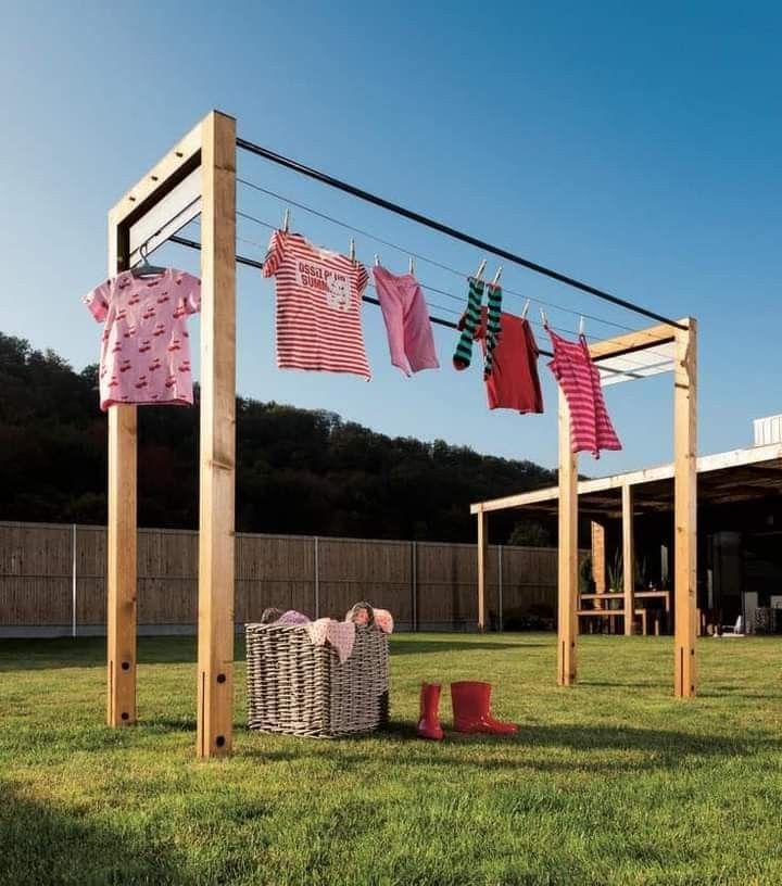 clothes are hung out to dry on the clothesline in an outdoor area with green grass