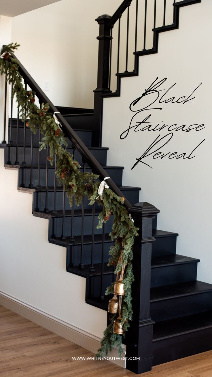 a christmas garland is hanging on the banister