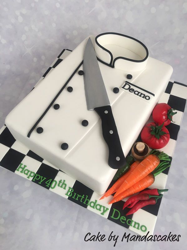 there is a cake that looks like a chef's outfit and vegetables on it