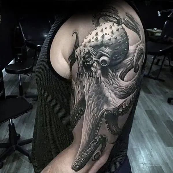 an octopus tattoo on the back of a man's arm, it looks like he is