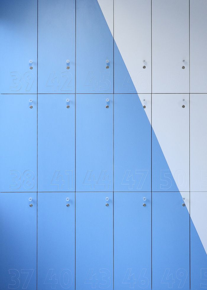 several blue and white lockers with numbers on them