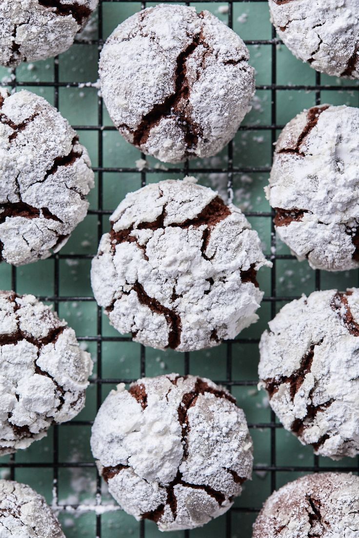 chocolate crinkle cookies on a cooling rack with mint leaves