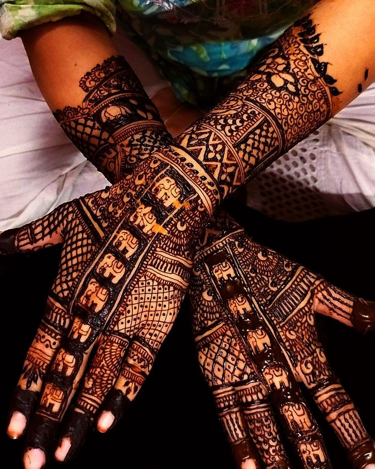 two hands with henna designs on them