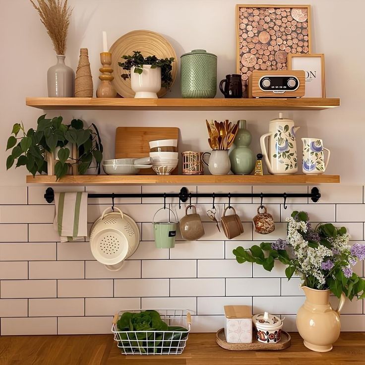 kitchen shelves with pots, pans and other items on them above a wooden table