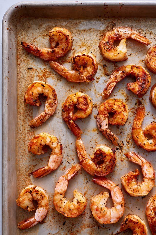 cooked shrimp on a baking sheet ready to go into the oven or grill for dinner