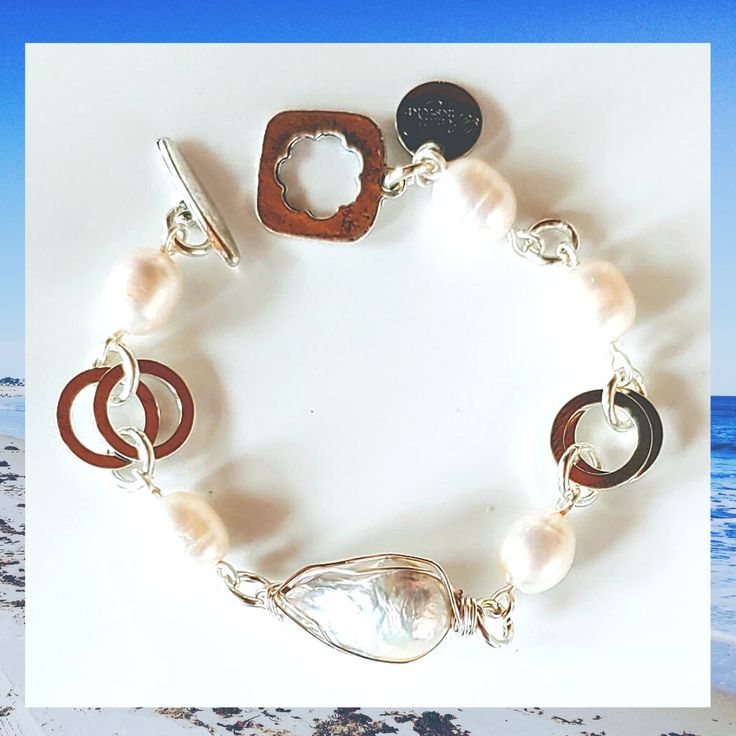 Wardrobe Must Have! Turn up your cuffs on your favorite blouse and show off this pretty bracelet! Must have for your Beauty In Stone collection! Center focal pearl is a freshwater baroque pearl wrapped in anti-tarnish silver wire. Each pearl will be unique in size and shape. Center pearl will be larger than the side pearls on the bracelet. All are genuine freshwater pearls. Easy toggle clasp. Now choose the Flower Toggle or the Rope Toggle. We're proud to see Susan wearing this many times in the Handmade Elegant Sterling Silver Pearl Bracelet, Modern Pearl Bracelet With Pearl Charm For Gift, Modern Pearl Bracelet With Pearl Charm As Gift, Modern Pearl Bracelet With Charm As A Gift, Metal Bracelets With Pearl Drop For Gift, Handmade Silver Pearl Bracelet, Elegant Pearl Bracelet Nickel Free, Elegant Pearl Bracelets Nickel Free, Elegant Handmade Sterling Silver Pearl Bracelet