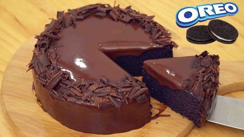 a chocolate cake on a cutting board with a knife