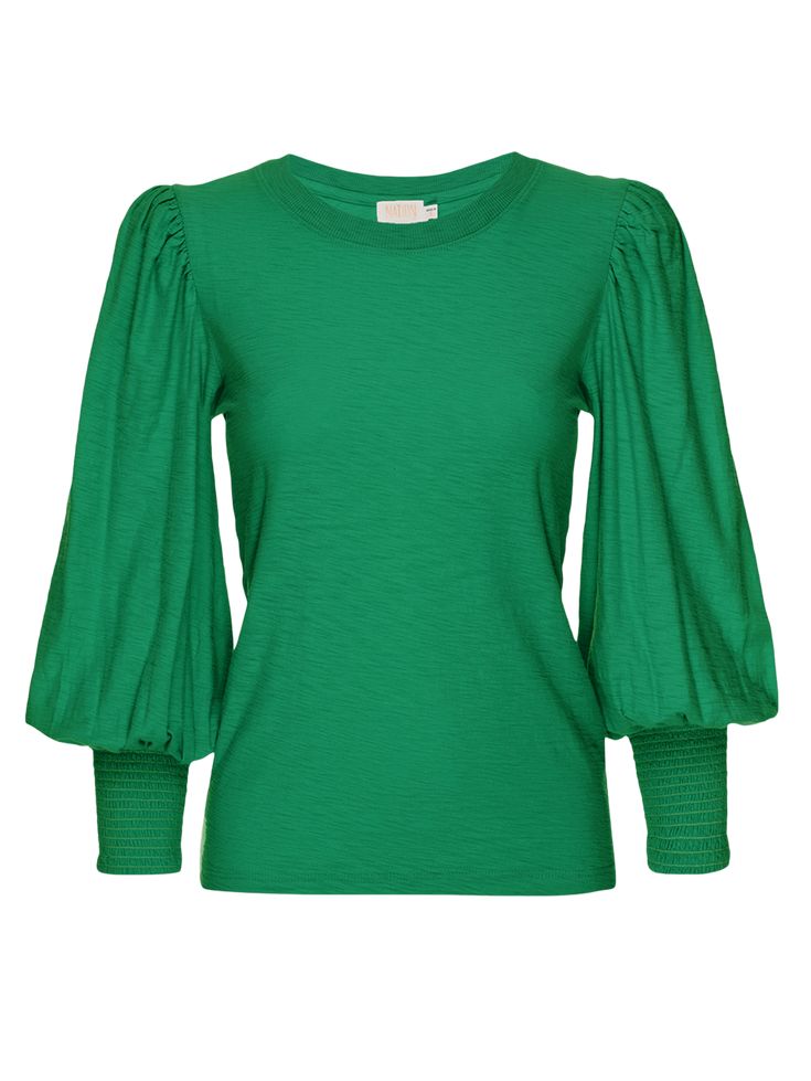 The ease of a comfortable cotton tee meets the look of a fancy blouse. An exaggerated shoulder, volume in the 3/4 length sleeve, and smocking around the cuff create a delightfully feminine look. It's our best seller for a reason. (This one comes in Verdant Green.) | Women's Loren Tee Top in Verdant Green | Ethical Essentials Chic Cotton Top With Bishop Sleeves, Spring Cotton Tops With Pleated Sleeves, Cotton Top With Gathered Sleeves Crew Neck, Cotton Crew Neck Top With Gathered Sleeves, Cotton Tops With Pleated Sleeves And Relaxed Fit, Green Balloon Sleeve Fall Top, Chic Green Tops With Gathered Sleeves, Chic Green Top With Gathered Sleeves, Fall Cotton Top With Balloon Sleeves