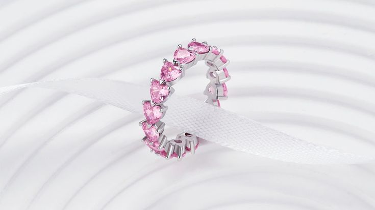 The name says it all, eternity is forever and this light pink heart stone eternity band is a perfect symbol for endless love! Gift this to a loved on this Valentines Day. This ring is a LIMITED EDITION Valentines special. So don't miss out because it wont be restocked once sold out! The Endless Love Ring has PREMIUM pink heart cut stones all around. It can be worn alone or stacked up with other rings to make a powerful impression. Enjoy the luxurious and Timeless design. Material: Full Sterling Pink Adjustable Heart Ring For Promise, Adjustable Pink Heart Ring For Promise, Pink Stackable Crystal Promise Ring, Pink Cubic Zirconia Eternity Band As Gift, Pink Eternity Band For Promise Ring, Pink Cubic Zirconia Stackable Rings For Anniversary, Pink Stackable Promise Rings, Pink Cubic Zirconia Eternity Band For Anniversary, Pink Stackable Rings For Promise