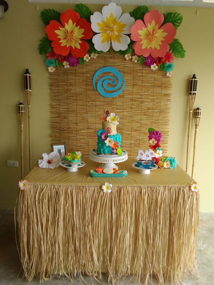 a table topped with a cake covered in flowers