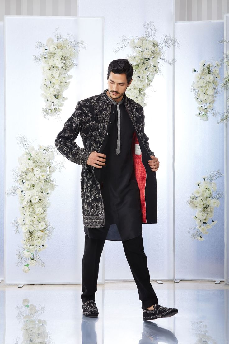 This black short sherwani set features tonal all over zardosi embroidery on a japanese base. It is paired with a black silk kurta and a japanese trouser. Complimenting stole and footwear is also available. From Seema Gujral's Tuscan Summer collection. DELIVERY TIMEPlease allow 4 months for your outfit to arrive.FABRIC DETAILSJapaneseProfessional cleaning only. Black Raw Silk Traditional Wear For Designer Occasions, Black Sherwani For Winter Wedding, Designer Black Raw Silk Traditional Wear, Black Ceremonial Sherwani For Winter, Black Wedding Sherwani For Winter, Black Winter Wedding Sherwani, Ceremonial Black Sherwani With Dabka Work, Elegant Black Kurta With Naqshi Detailing, Formal Black Sherwani With Dabka Work