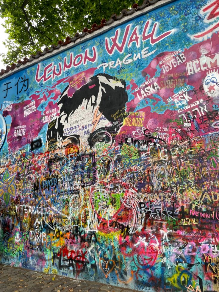 a wall covered in lots of colorful graffiti