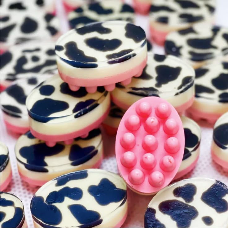 there are many cookies that have been decorated with pink and blue designs on them,