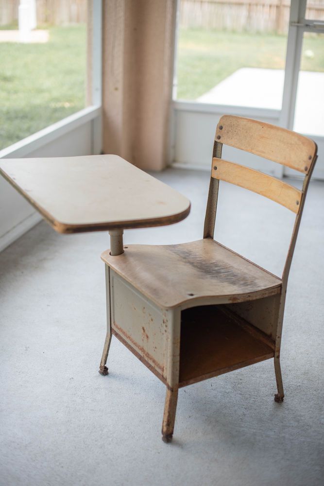 an old wooden chair and table in a room