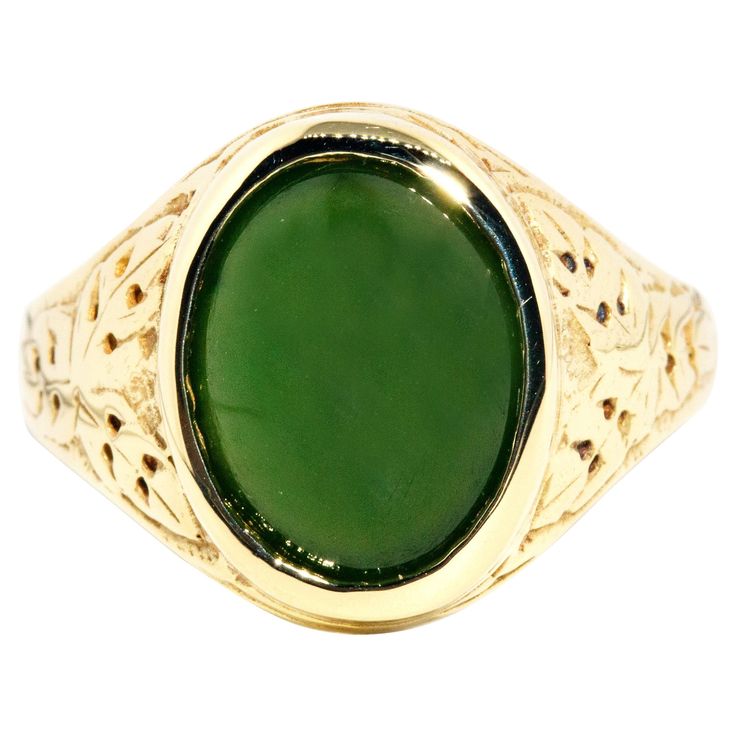 Forged in 14 carat yellow gold, this gorgeous vintage ring, circa 1980s, features an opulent deep green Nephrite jade cabochon set on patterned domed shoulders. This lovely adornment has been named The Logan Ring. She is a graceful everyday ring with wonderfully dark green hues and is fit for any occasion. The Logan Ring Gem Details The oval deep green Nephrite jade cabochon measures approximately 13 x 10 millimetres. Ring Size T 1/2 (Australia and UK sizing) or 10 (US and Canada) The Logan Ring Classic Green Jewelry With Polished Finish, 14k Gold Green Cabochon Jewelry, Antique Green Emerald Ring With Polished Finish, Classic Green Jade Jewelry, Green Oval Cabochon 14k Stamped Jewelry, Heirloom Style Green Emerald Ring With Polished Finish, Heirloom Style Polished Emerald Ring, Classic Polished Jade Jewelry, Classic Green Cabochon Emerald Ring