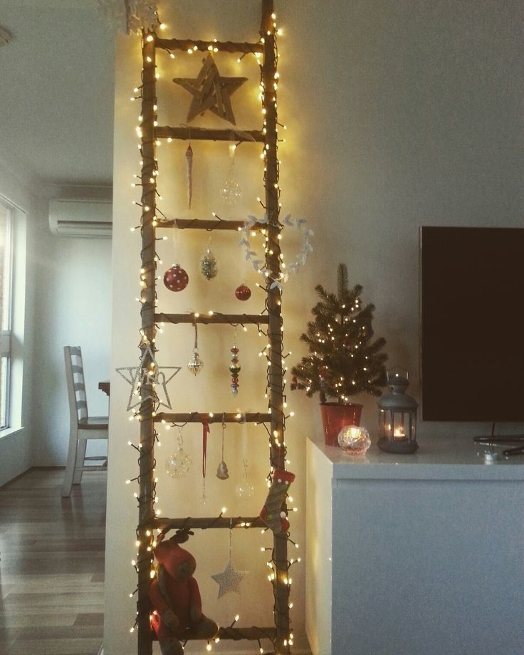 a ladder is decorated with christmas lights and ornaments