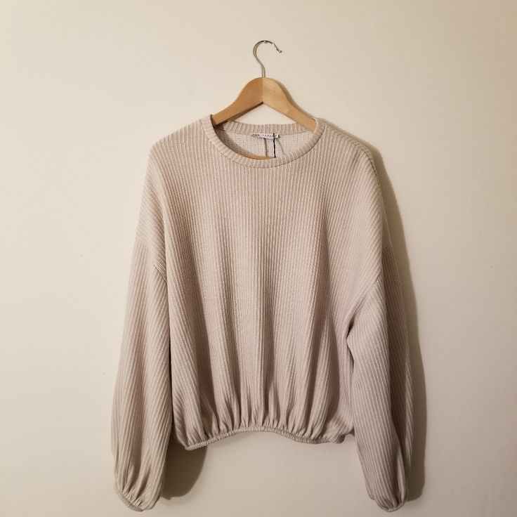 Incredibly Comfortable And Stylish, This Oversized Zara Sweatshirt Is Perfect For Any Closet. Features A Soft Cream Color With Light Ribbing Throughout The Body. Includes Nice Elastic Trim On The Bottom And Each Sleeve, Giving It A Good Amount Of Stretch For The Perfect Fit. Pairs Perfectly With Your Favorite Pair Of Jeans Or Tucked Into A Skirt! 54% Polyester And 46% Cotton For An Ultra Soft Feel. Brand New With Tags! Size Medium. Cozy Knit Top With Balloon Sleeves, Cozy Knit Tops With Balloon Sleeves, Oversized Ribbed Cropped Sweater With Crew Neck, Oversized Ribbed Crew Neck Cropped Sweater, Zara Crew Neck Sweatshirt With Ribbed Cuffs, Oversized Ribbed Cropped Cotton Sweater, Casual Soft Knit Tops With Balloon Sleeves, Cream Cropped Crew Neck Sweater With Ribbed Cuffs, Zara Long Sleeve Sweater With Ribbed Cuffs