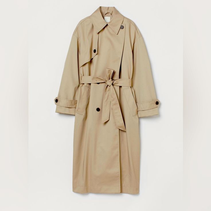 Calf-Length, Oversized, Double-Breasted Trenchcoat In Twill With A Slight Sheen. Notched Lapels, Yoke At One Side Of Front With A Button, And Welt Front Pockets. Dropped Shoulders, Wide Sleeves, And Cuffs With Tab And Decorative Button. Removable Tie Belt At Waist And A Vent At Back. Lined. Fit: Oversized Composition - Shell: Polyester 62%, Cotton 38%, Lining: 100% Polyester Chic Oversized H&m Outerwear, H&m Oversized Outerwear For Fall, Oversized H&m Outerwear For Work, H&m Classic Spring Outerwear, Pink Suede Jacket, Herringbone Tweed Jacket, Oversized Trench, Lightweight Trench Coat, Suede Trench Coat