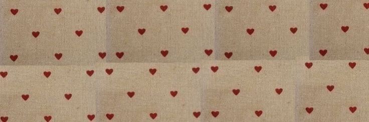 red hearts are arranged on beige fabric